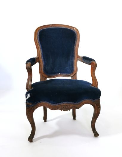 null Armchair with a high cabriolet back in moulded and carved beech wood; whiplash...