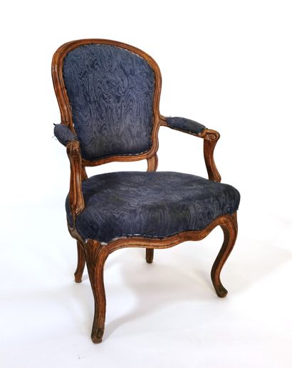 null Armchair with cabriolet back in moulded and carved beechwood; the arm brackets...