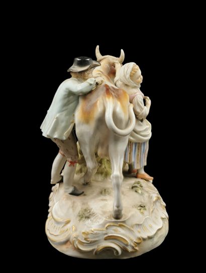 null MEISSEN 

Porcelain group representing a couple of peasants around a cow on...