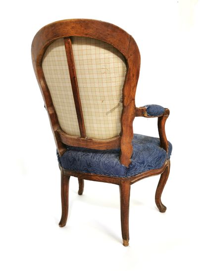 null Armchair with cabriolet back in moulded and carved beechwood; the arm brackets...