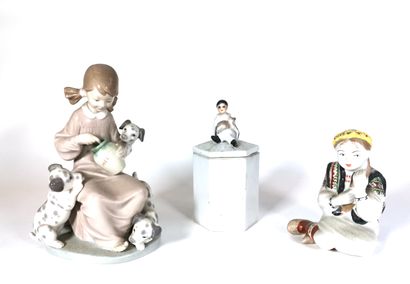 null Suite of three porcelain pieces including two figurines and a covered pot, the...