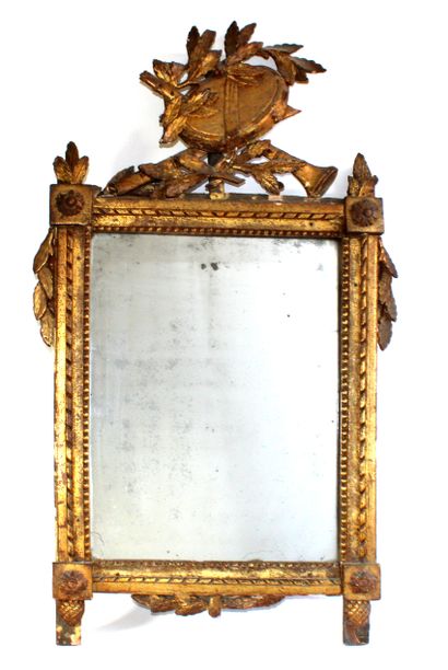 null Miroir de style Louis XVI en bois et stuc doré à décor d'un trophée à l'ammortissement,...