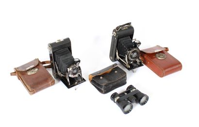 null Two bellow cameras and a pair of binoculars