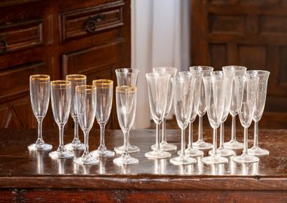 null Six crystal Champagne flutes with gold net decoration, eleven glass Champagne...