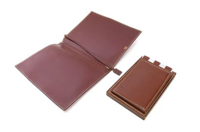 null HERMÈS House
Writing set including a leather notebook case (signed), a leather...