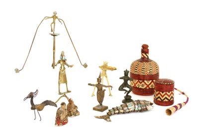 null Objects of showcase including an African statuette in copper representing acrobats,...
