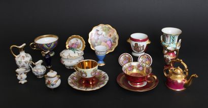 null Set of eighteen porcelain display objects including cups and their saucers,...