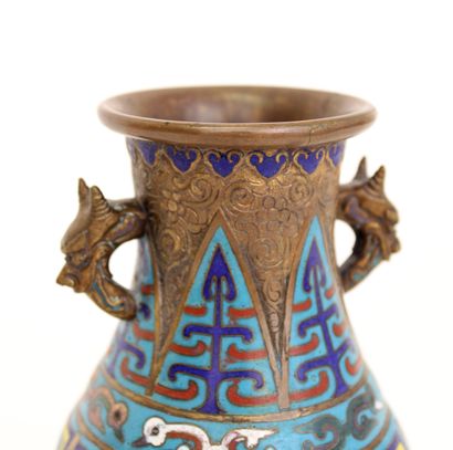 null CHINA, 19th century
A small copper vase with two handles with dragon heads and...
