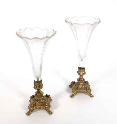 null Two cut crystal vases with petal-shaped necks resting on a quadripod base in...