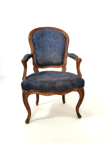 null Armchair with cabriolet back in molded and carved beech; the brackets of armrests...