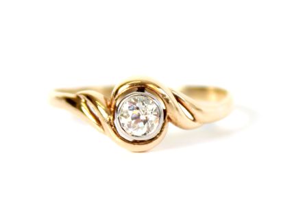 null Ring in two-tone 18K (750 thousandths) gold, set with a round old-cut diamond...