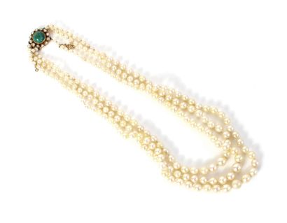 null Necklace composed of three rows of cream-colored cultured pearls, the clasp...