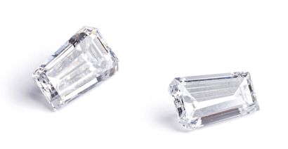 null Two trapeze diamonds with degrees on paper, each weighing 0.67 carat.
Accompanied...