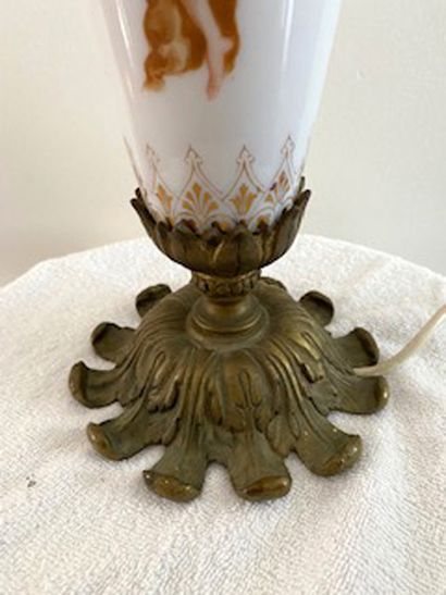 null 
Porcelain and brass baluster lamp with cupid decoration. 

European electric...