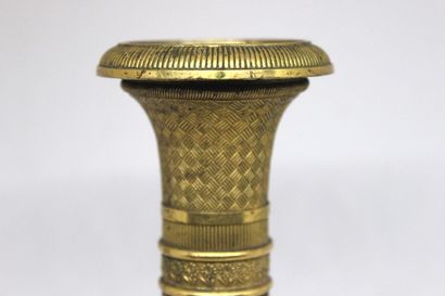 null Candlestick in gilded brass with fluted shaft, the base decorated with vine...