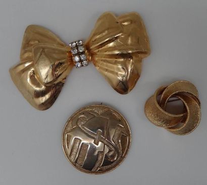 null Trois broches en métal doré, dont une circulaire par Pierre BALMAIN.