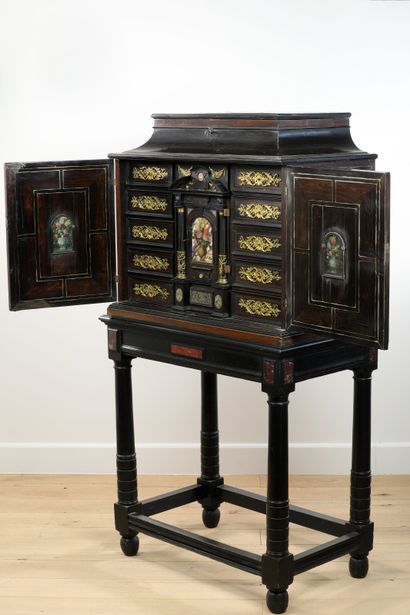 null 
Small cabinet in amaranth veneer with geometrical decoration, framed with brass...