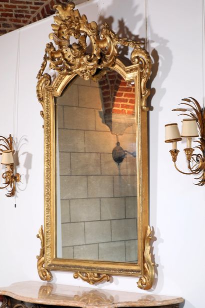 null 
Large gilded wooden mirror with foliage frieze decoration. Large pediment decorated...