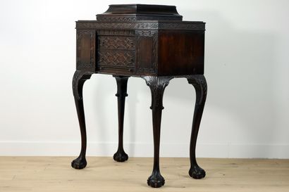 null 
Carved mahogany cabinet decorated with interlacing friezes and palmettes resting...