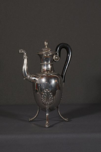 null Large silver tripod pourer with palmette motif and friezes of eggs. Claw feet...