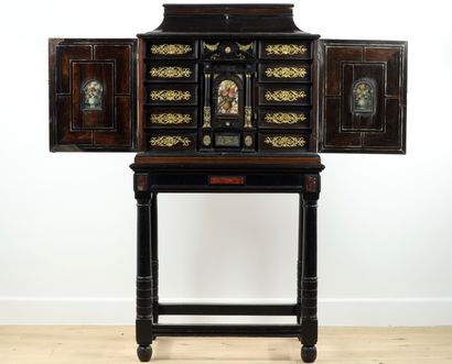 null 
Small cabinet in amaranth veneer with geometrical decoration, framed with brass...