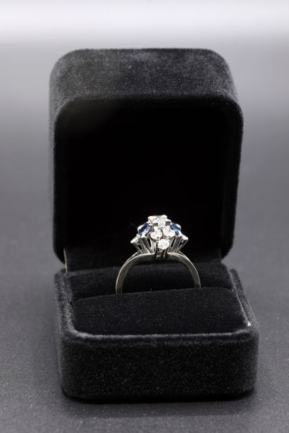 null 
White gold and platinum ring set with a central emerald cut diamond approximately...