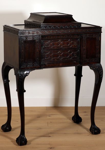 null 
Carved mahogany cabinet decorated with interlacing friezes and palmettes resting...