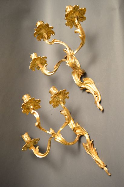 null Beautiful pair of ormolu sconces in the Louis XV style with three arms of lights....