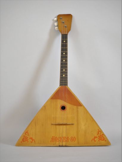 null Triangular wooden balalaika with three strings with red coloured decoration...