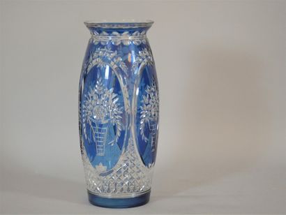 null A large blue cut crystal vase decorated with flowering baskets in reserves....