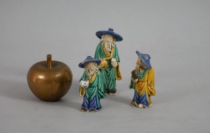 null Suite of three Chinese figures in glazed biscuit.