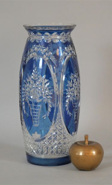 null A large blue cut crystal vase decorated with flowering baskets in reserves....
