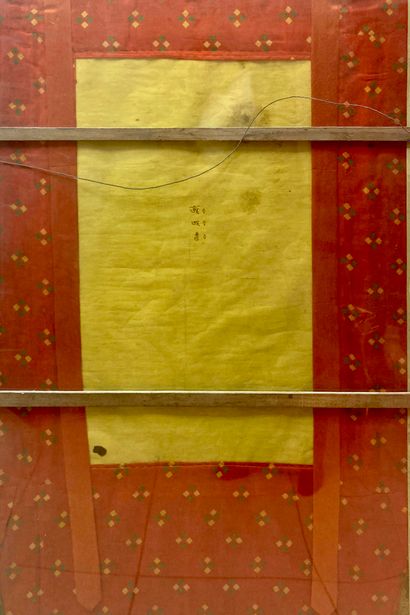 null Tibet, 20th century, Tangka framed under glass with silk brocade representing...