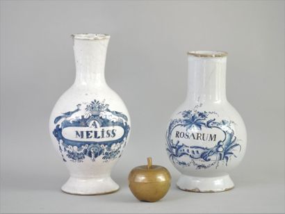 null TWO PHARMACY VASES, "A ROSARUM" and "A. MELISS".

Earthenware with blue painted...