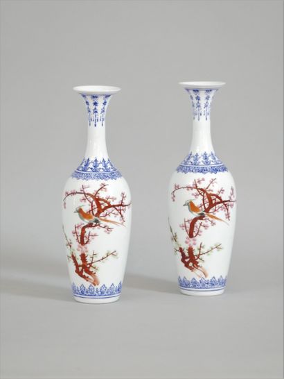 null Pair of white porcelain vases decorated with a bird on a cherry tree in bloom...
