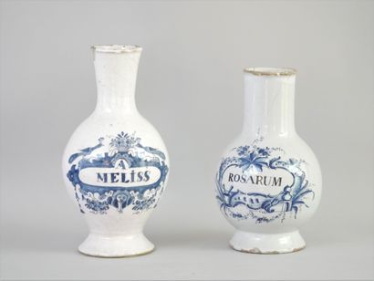 null TWO PHARMACY VASES, "A ROSARUM" and "A. MELISS".

Earthenware with blue painted...
