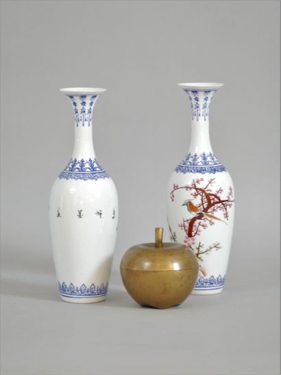 null Pair of white porcelain vases decorated with a bird on a cherry tree in bloom...