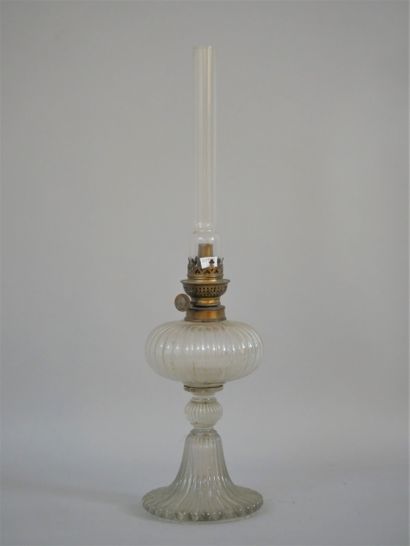 null 
Glass kerosene lamp with gadroon decoration composed of a flared foot, a knot...