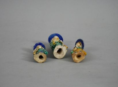 null Suite of three Chinese figures in glazed biscuit.