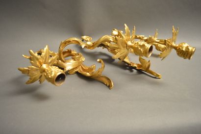 null A pair of ormolu sconces in the Louis XV style with large foliage, two arms...