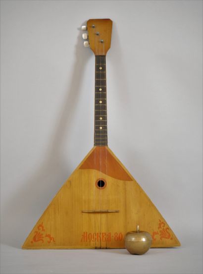 null Triangular wooden balalaika with three strings with red coloured decoration...