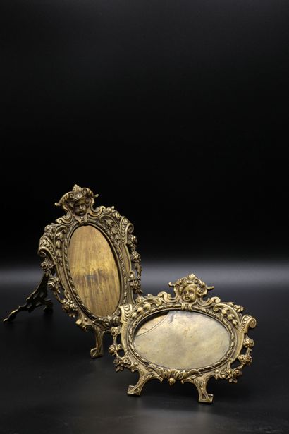 null A pair of gilt brass patinated photo frames decorated with cherubs heads. Early...