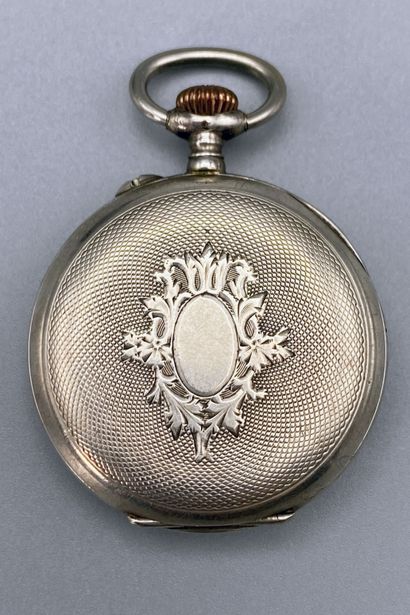 null Silver collar watch with a shield design on a guilloche background. Late 19th

century....