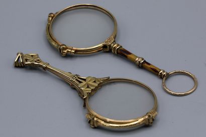 null Two pairs of gilt metal lorgnons, one with cloverleaf decoration and the other...