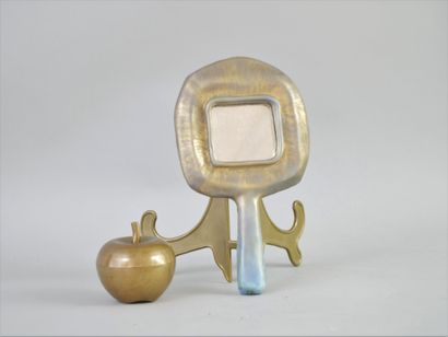 null Mirror forming a face to hand in glazed ceramic with turquoise and gold gradation.

Irregular...