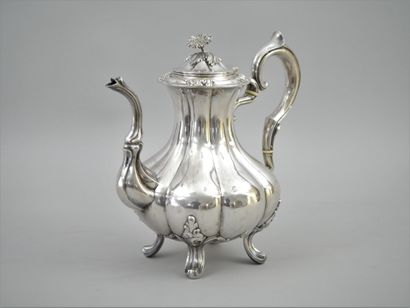 null Silver embossed teapot with a scrolled handle and ivory ferrules; a scrolled...