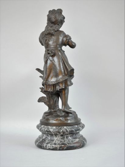 null Augustin MOREAU (1834-1917) Girl with a bird. A bronze proof with brown patina...