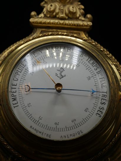 null Gilt bronze barometer with white and black enamelled dial, marked " Baromètre...