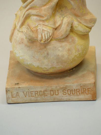 null The smiling Virgin of Lisieux. Large terracotta sculpture with ochre patina...