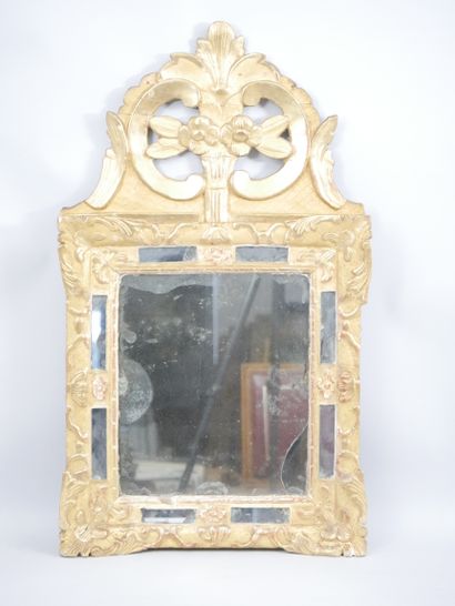 null A mirror with acanthus leaves, the pediment with foliage and flowers. Wood and...